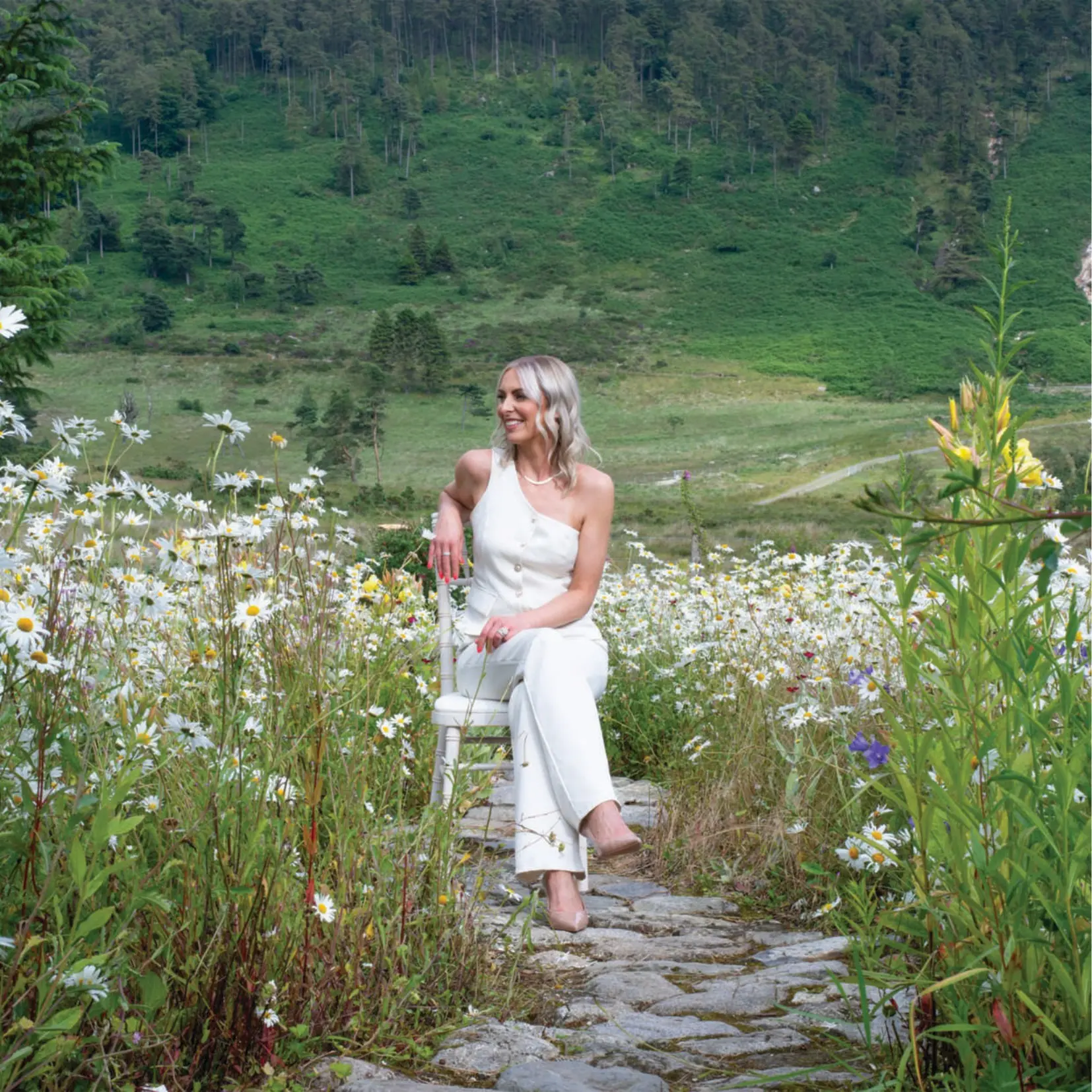 A bride among wildflowers with the Mourne Mountains beyond